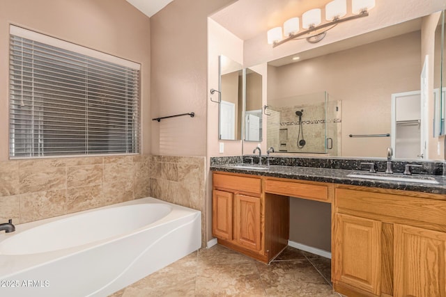 full bath with a shower stall, double vanity, a bath, and a sink