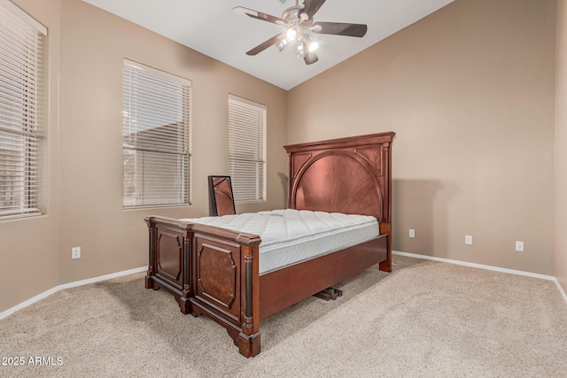carpeted bedroom with baseboards, ceiling fan, and vaulted ceiling