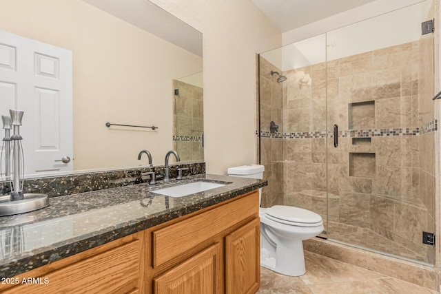 full bathroom with toilet, vanity, a stall shower, and tile patterned flooring