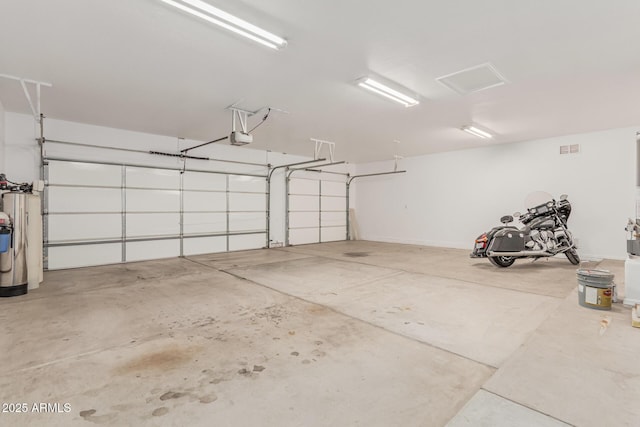 garage featuring visible vents and a garage door opener