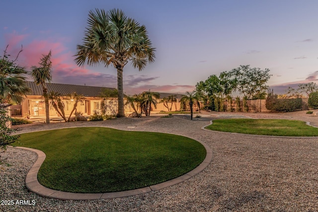 view of yard at dusk
