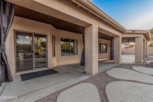 property entrance featuring a patio area and stucco siding