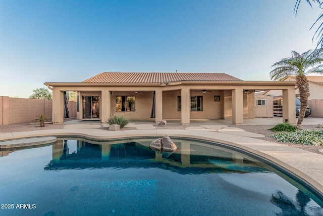 view of pool with a fenced in pool, a patio, fence, and a ceiling fan