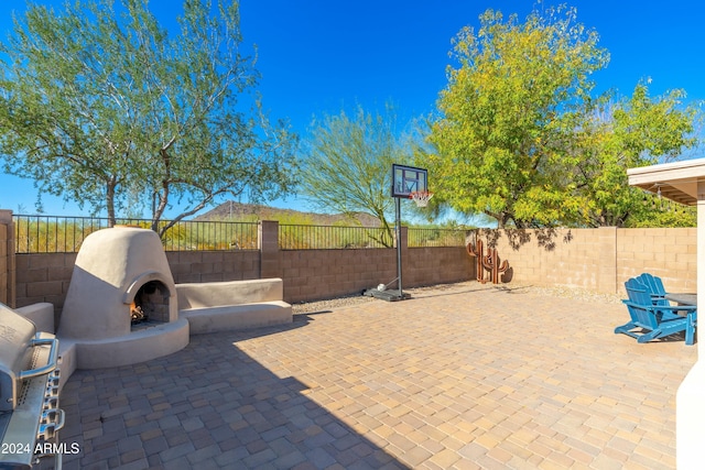 view of patio / terrace with an outdoor fireplace