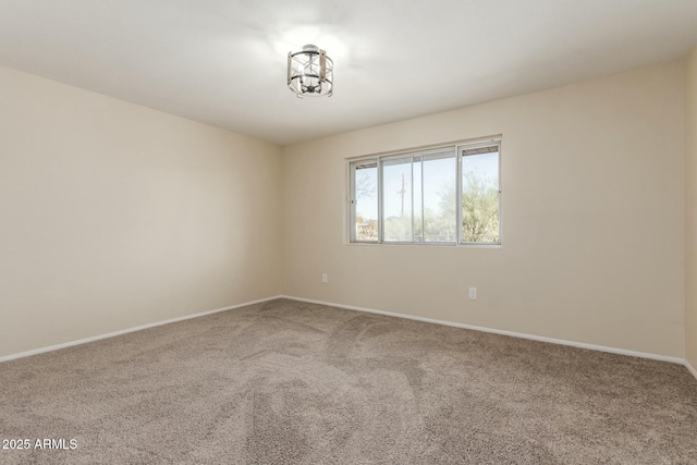 carpeted empty room with baseboards