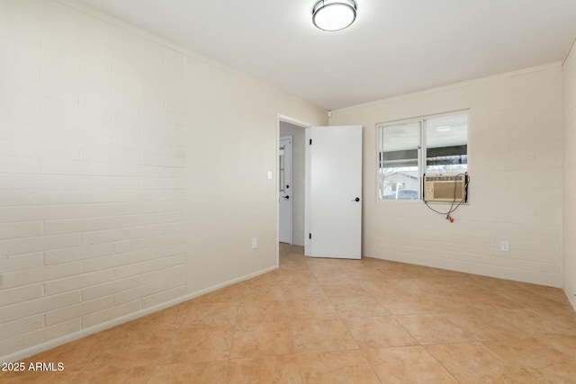 empty room featuring light tile patterned floors, brick wall, and cooling unit