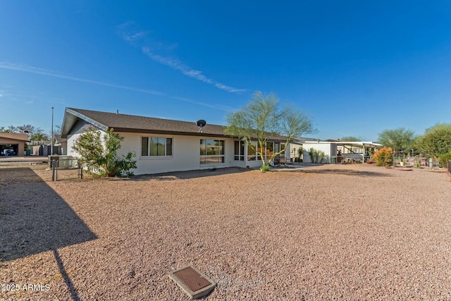 rear view of house featuring fence