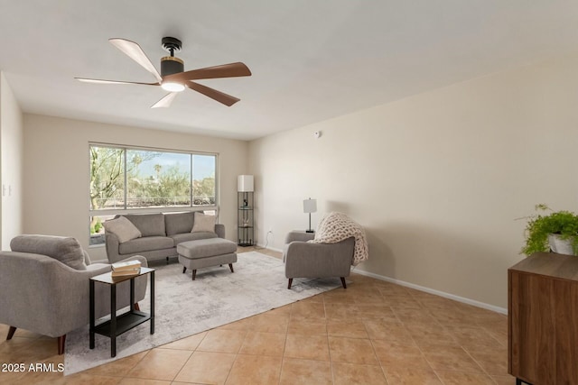 living room featuring light tile patterned floors, ceiling fan, and baseboards