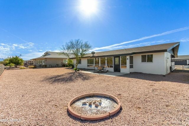 rear view of house with a patio and fence