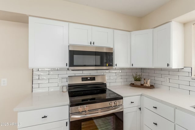 kitchen with white cabinetry, tasteful backsplash, appliances with stainless steel finishes, and light countertops