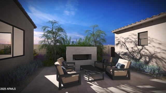 patio terrace at dusk with outdoor lounge area and a fenced backyard