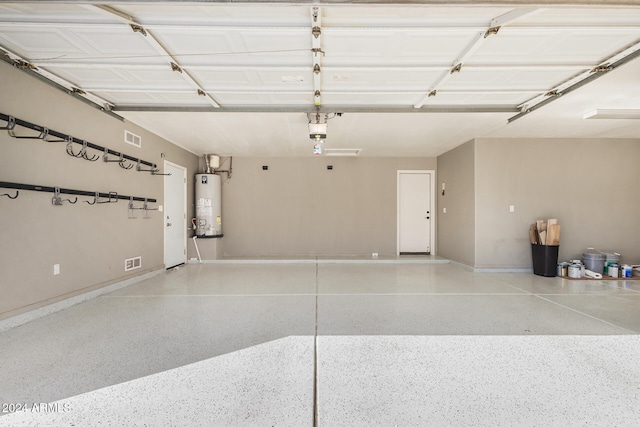 garage with water heater and a garage door opener