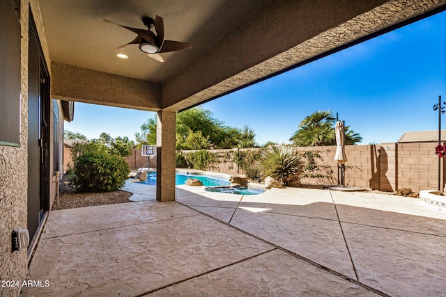 view of patio with a fenced in pool and ceiling fan