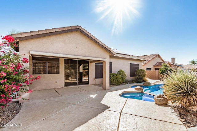 view of swimming pool with a patio and an in ground hot tub