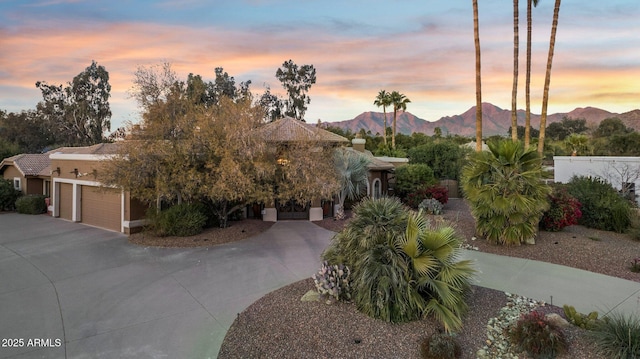 view of front facade with a garage and a mountain view