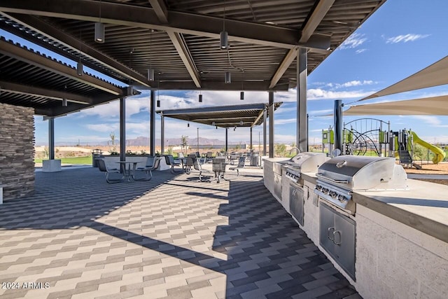 view of patio featuring area for grilling, grilling area, and playground community