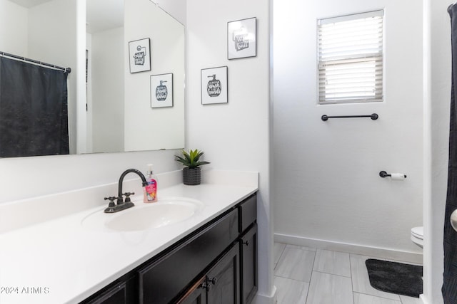 bathroom featuring vanity and toilet