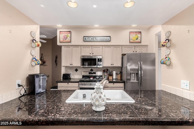 kitchen featuring tasteful backsplash, sink, and stainless steel appliances