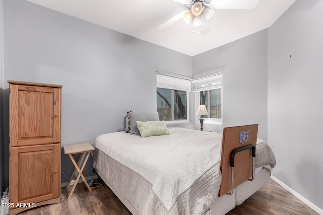 bedroom with dark wood-type flooring and ceiling fan