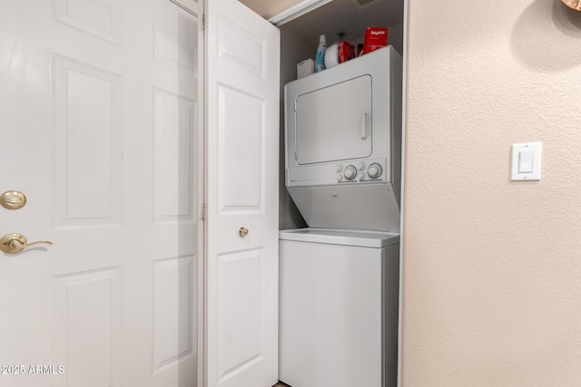 laundry room featuring stacked washer and clothes dryer