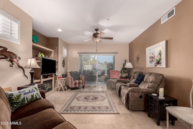 tiled living room featuring ceiling fan