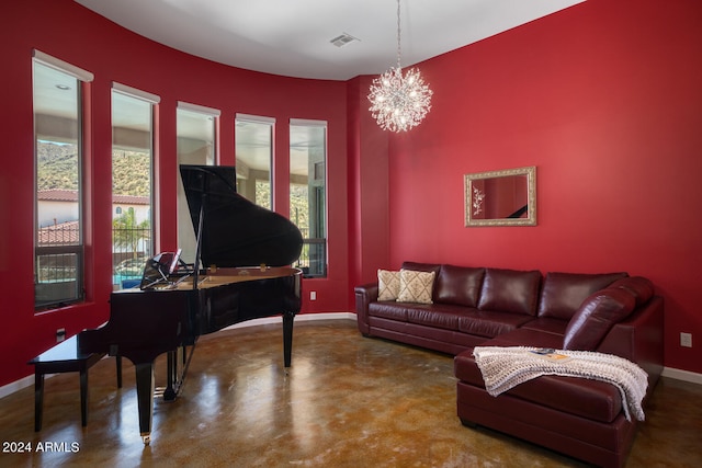 living room featuring a chandelier and concrete flooring