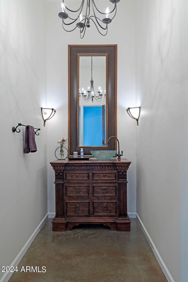 bathroom with vanity and a notable chandelier