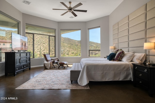 bedroom featuring a mountain view and ceiling fan