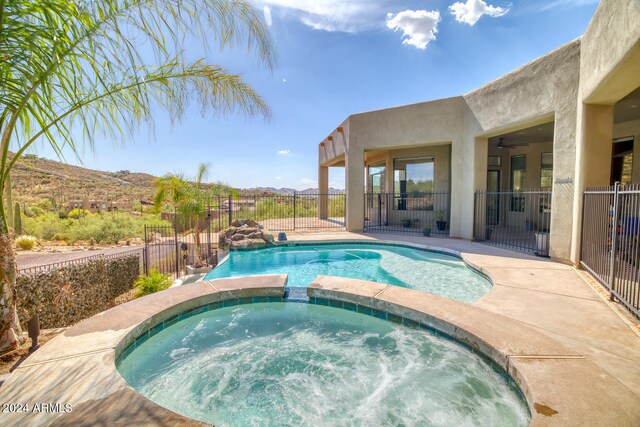 view of swimming pool with an in ground hot tub and a patio