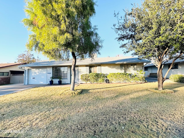 ranch-style house featuring a front yard and a garage