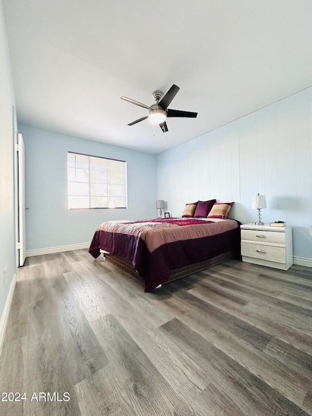 bedroom with light hardwood / wood-style floors and ceiling fan