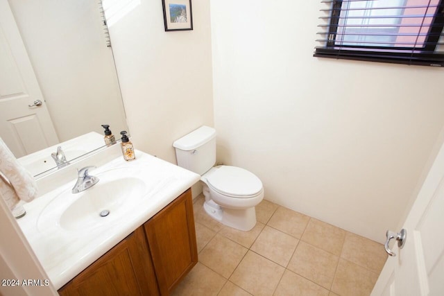 bathroom featuring tile patterned flooring, vanity, and toilet