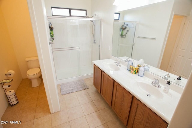 bathroom featuring tile patterned floors, toilet, vanity, and walk in shower