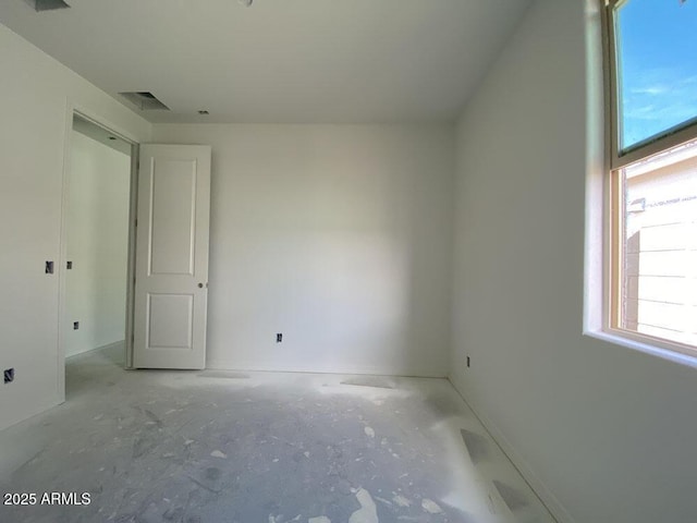 unfurnished room with visible vents