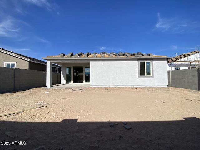 back of property featuring a fenced backyard and stucco siding