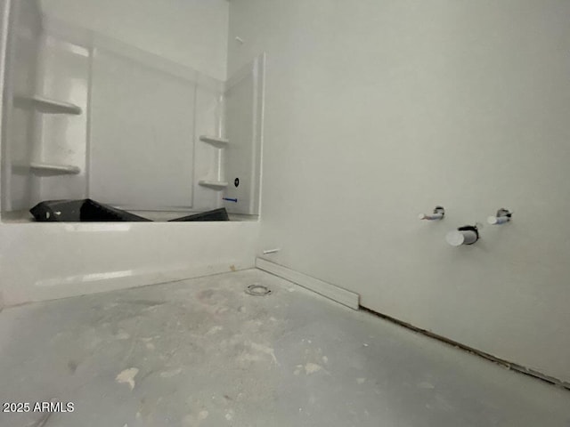 bathroom with a shower, unfinished concrete flooring, and a bathing tub