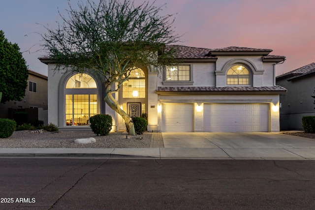 7247 W Buckskin Trl, Peoria, AZ 85383 - mediterranean / spanish-style house featuring a garage, stucco siding, driveway, and a tile roof