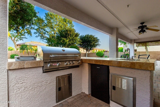 7247 W Buckskin Trl, Peoria, AZ 85383 - fenced backyard featuring an outdoor kitchen and a ceiling fan