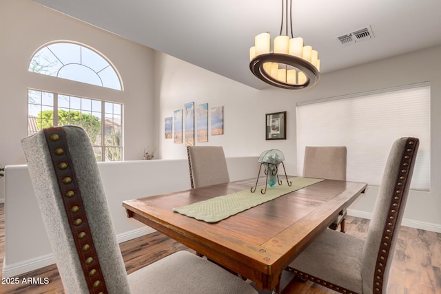 7247 W Buckskin Trl, Peoria, AZ 85383 - dining space featuring wood finished floors and a chandelier
