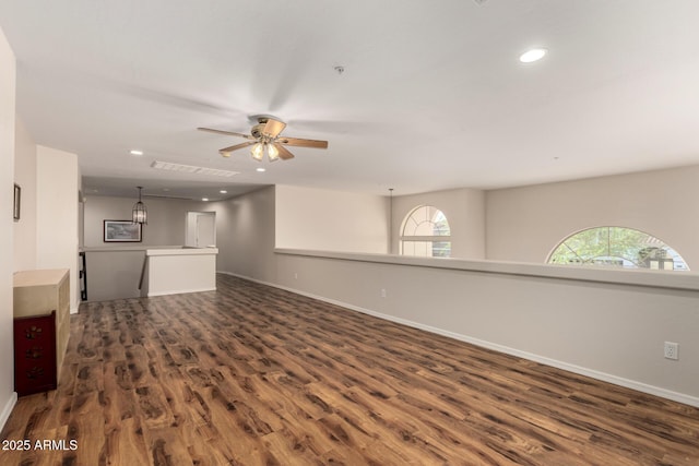7247 W Buckskin Trl, Peoria, AZ 85383 - unfurnished living room with dark wood finished floors, ceiling fan, and recessed lighting