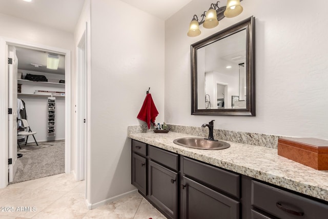 7247 W Buckskin Trl, Peoria, AZ 85383 - bathroom featuring vanity, tile patterned floors, and a walk in closet