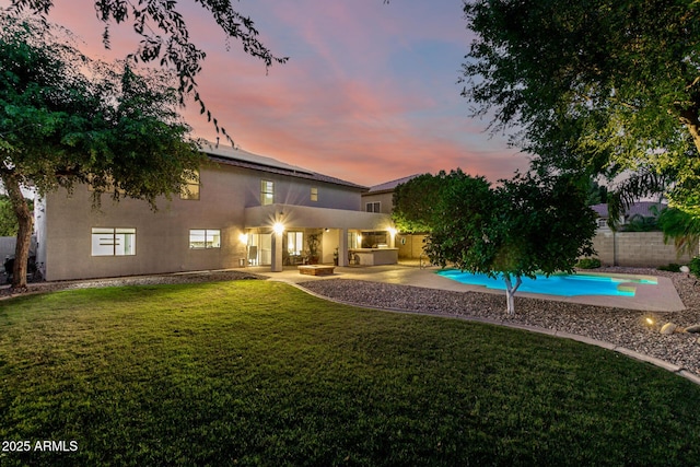 7247 W Buckskin Trl, Peoria, AZ 85383 - back of house with stucco siding, a fenced backyard, a patio, and solar panels