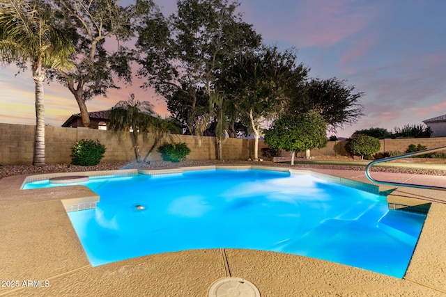 7247 W Buckskin Trl, Peoria, AZ 85383 - pool at dusk featuring a fenced backyard and a jacuzzi