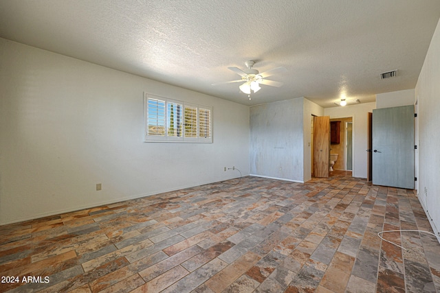 unfurnished room featuring a textured ceiling and ceiling fan