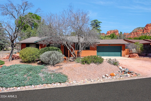 ranch-style home featuring a garage