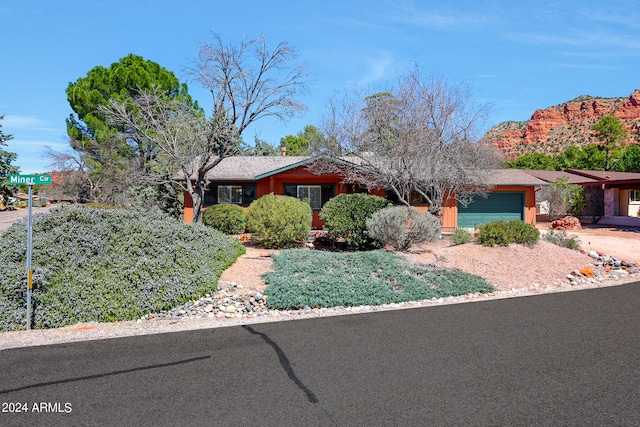 ranch-style home with a mountain view and a garage