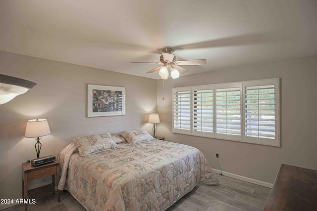 bedroom featuring hardwood / wood-style floors and ceiling fan