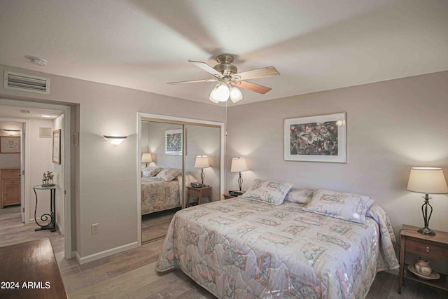 bedroom featuring light hardwood / wood-style flooring, a closet, and ceiling fan