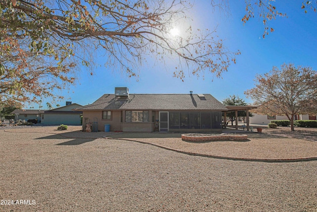 back of house featuring a sunroom and central AC unit