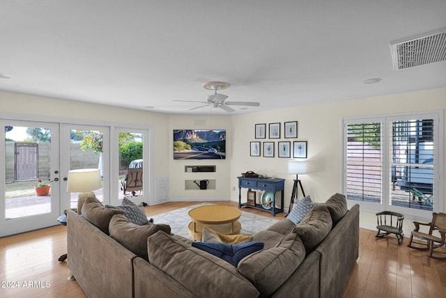 living room with ceiling fan, wood-type flooring, and french doors